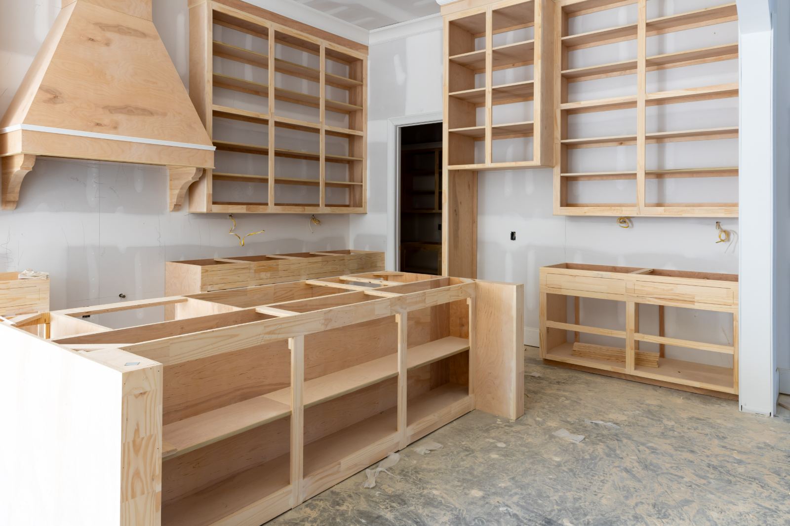 Custom wooden kitchen cabinets under construction in showroom