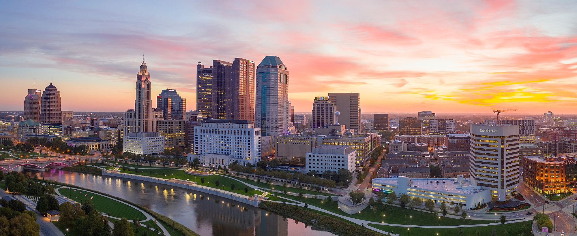 Columbus downtown skyline at sunset with Scioto River and illuminated buildings